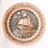 An early 20th century copper charger, ships scene pierced foliate border,