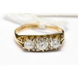 A nine carat gold three stone ring, with cubic zirconia or similar stones,