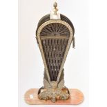 A Victorian brass and metal fan fire screen