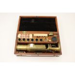 A brass cased microscope, appears unsigned, complete with key.