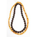 An amber necklace of faceted beads alternately strung with spaces and another necklace (2)