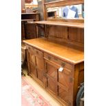 A late Victorian oak sideboard, having two drawers over two doors,