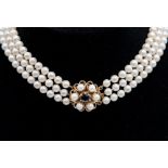 A cultured pearl choker with 9ct gold clasp,