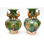 Pair of three handled Majolica terracotta vase having raised vine and dragon pattern,
