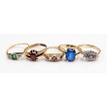 A group of five 9ct gold dress rings, comprising an emerald and diamond set ring,