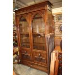 A late 19th to early 20th Century walnut two door bookcase,