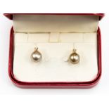 A pair of pearl and diamond stud earrings, in 18ct gold, single coffee coloured pearl studs,