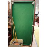 A snooker table with a box of snooker balls, triangles,