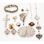 A quantity of silver jewellery to include a marcasite bracelet, brooch, nurses buckle, crosses,