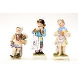 Three Dresden miniature figures, modelled as a peasant boy and girl and cupid,