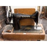 Four Singer sewing machines, one in leather case,