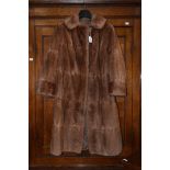 A ladies brown fur coat.
