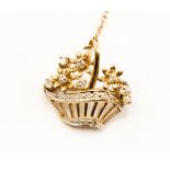 A circa 1940's yellow metal small brooch styled as a basket of flowers set with small diamonds