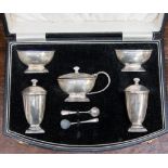 A George V silver boxed condiment set, Birmingham 1935, comprising a pair of sifters,