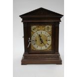 A French cased clock, signed, brass face oak temple style case,