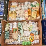 A large collection of assorted ceramic toast racks, mostly hand painted, including Crown Devon,