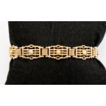 An Edwardian 15ct gold link bracelet set with four diamonds and four seed pearls, gross weight 22.