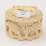 A heavily carved ivory oval box and cover