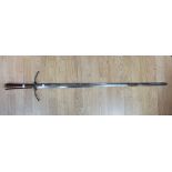 A large Crusader style sword. Wooden grip with brass pommel and crossguard.