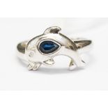 A sapphire platinum ring in the form of a dolphin,