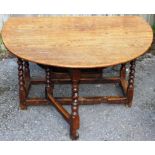 An early 18th Century joined oak gateleg table, the later plank top,