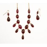 A 9ct and garnet necklace and drop earrings ensuite,