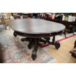 A large traditional oak pedestal dining table,