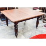 A large Victorian mahogany dining table, complete with a single leaf,