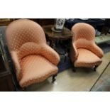 Two late Victorian upholstered armchairs, upholstered in matching salmon pink upholstery