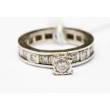 A diamond white metal solitaire eternity ring, the centre raised diamond weighing approximately 0.