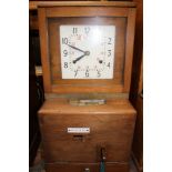 A mid 20th Century mahogany clocking in clock,