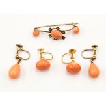 Three items of coral set 9ct gold comprising a brooch and two pairs of earrings