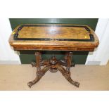 A Victorian walnut and ebonised fold over card table