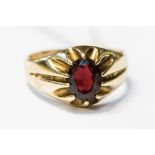 A garnet and 9ct gold gentleman's signet ring, set with an oval garnet, size V,