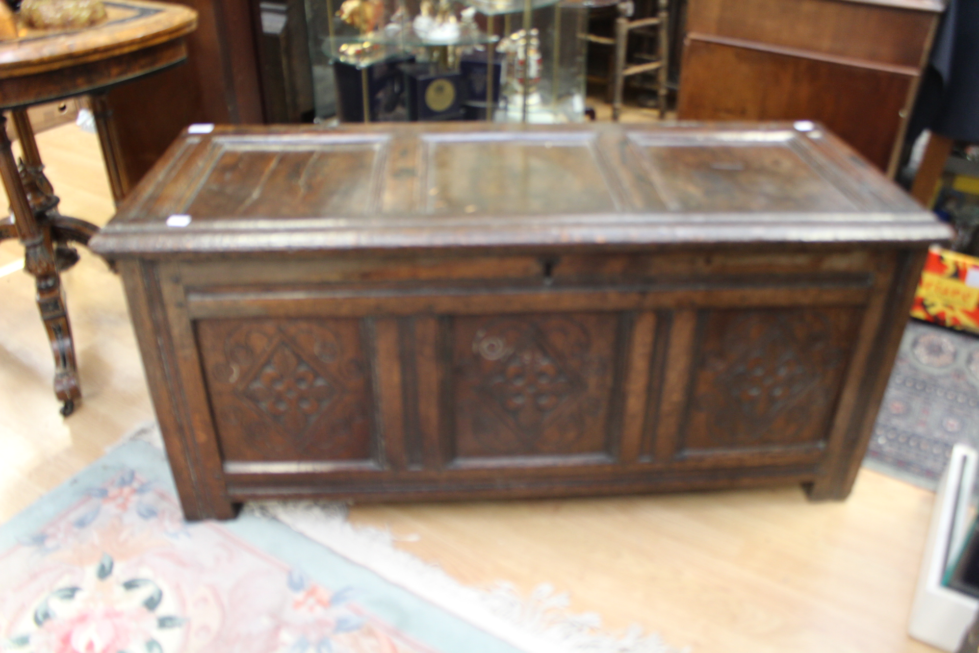 An early 18th Century carved oak blanket chest with candle box inside