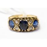 A sapphire and diamond ring, the three graduated oval sapphires interspersed with four diamonds,