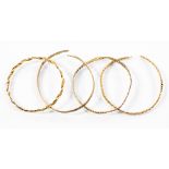 Four yellow metal bangles, Far Eastern, with a combined total gross weight approx 42.