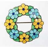 A silver enamelled wreath brooch with yellow and blue daises with green leaves, with an open centre,