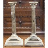 A pair of silver plated Corinthian candlesticks