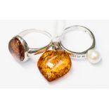 An amber pendant with silver loop, together with a silver ring set with amber, size S,