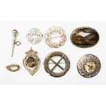 A group of eight Scottish and Celtic style brooches, one set with banded agate,