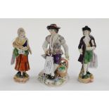 A pair of Continental hard paste figures and a gardener figure (3)