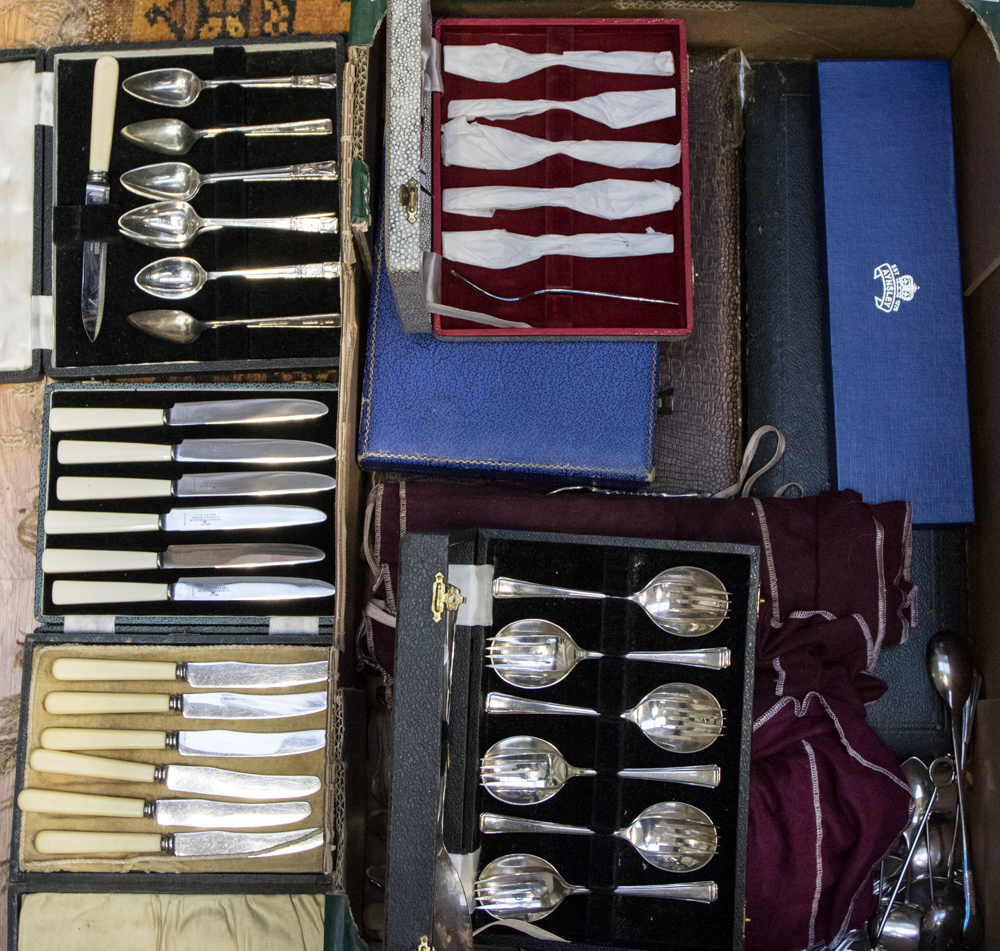 A box containing cased and loose flatware to include knife sets, dessert spoons, servers,