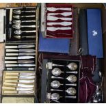 A box containing cased and loose flatware to include knife sets, dessert spoons, servers,