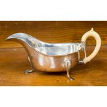 A George V silver and ivory handled sauce boat in George II style, Sheffield 1911,