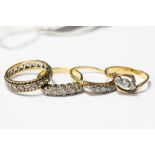 Three diamond rings in 18ct gold, comprising one three stone cross over ring,