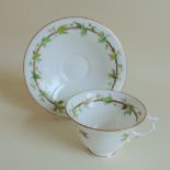 A Royal Worcester teacup and saucer, with vine leaf decoration, circa 1909, approx size, cup 6.