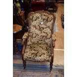 A Victorian walnut upholstered spoon back armchair