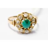 A diamond and turquoise cluster ring with central claw setb turquoise surrounded by a border of ten