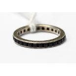 A .935 silver full eternity ring channel set with square black stones, size K, 1.